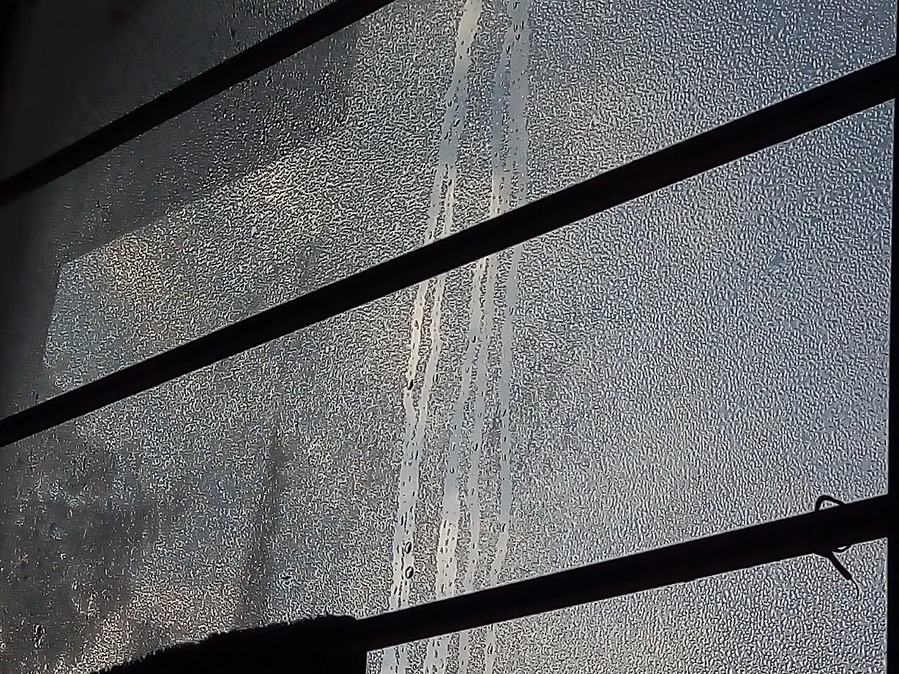 Condensation on glass behind window bars